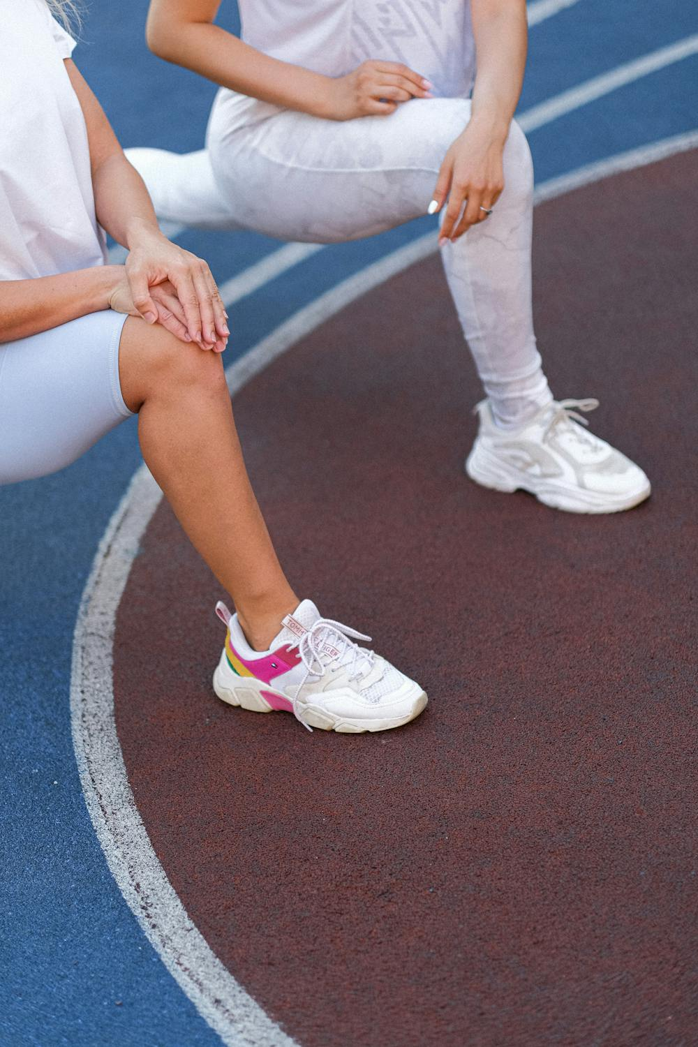 Two people exercise wearing sneakers.